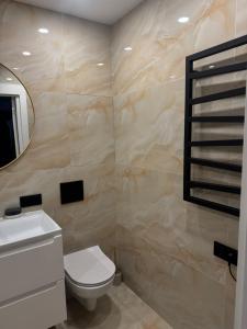 a bathroom with a toilet and a mirror at The Hidden Gem Rukla in Rukla +5 photos