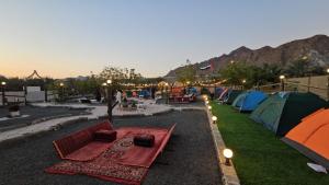 a group of tents with tables and lights on the grass at Daftah Valley Farmhouse in Daftah