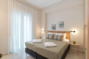 a bedroom with a large bed with two pillows on it at Chania Experience Residence in Chania