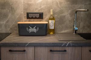 a bottle of wine sitting on a counter next to a container at Chania Experience Residence in Chania +91 photos