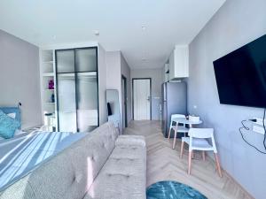 a living room with a couch and a table at Title Ledgendary 7th Floor in Bang Tao Beach