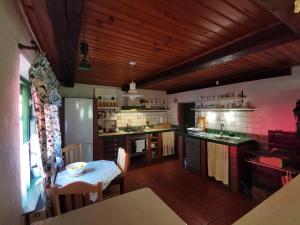 a kitchen with a table and a dining room at Zielone Wzgórze in Lasowka