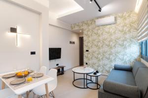 a living room with a couch and a table at Chania Experience Residence in Chania