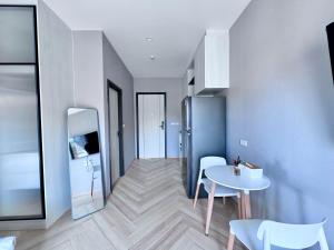 a room with a table and a table and chairs at Title Ledgendary 7th Floor in Bang Tao Beach