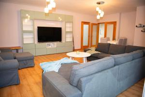 a living room with a couch and a tv at Meio Mundo in Várzea