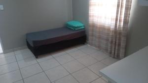 En eller flere senge i et værelse på Bellville Backpackers