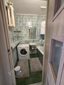 a small bathroom with a toilet and a sink at Centrum Jagoda in Pisz