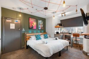 a bedroom with a large bed with blue pillows at One Broad Street in Brighton & Hove