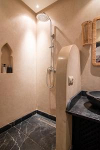 un baño con lavabo y ducha en Riad Bloom, en Oulad Akkou 21 fotos más