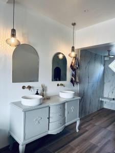 a bathroom with two sinks and two mirrors at Room in exclusive villa in sentral Oslo in Oslo