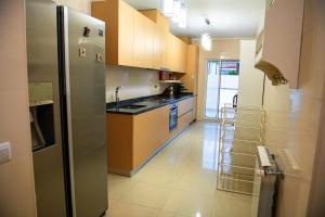 a kitchen with a stainless steel refrigerator and cabinets at Meio Mundo in Várzea