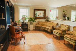 a living room with couches and a table at TheLodge in Welzheim