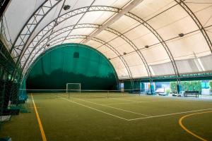 einen Tennisplatz in einem Gebäude mit Tennisschläger in der Unterkunft Residenz La Selva Studio-Apartments in Ghiffa