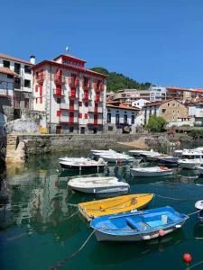 a group of boats docked in a harbor with buildings at Singular piso junto al puerto - Arostegi Etxea in Bermeo