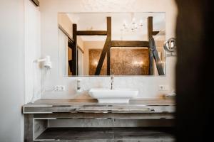 a bathroom with a sink and a large mirror at Schlosshotel Stecklenberg in Thale +43 photos