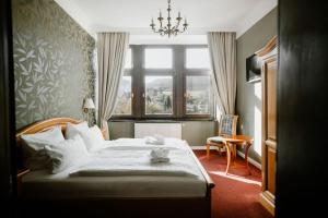 a bedroom with a large bed and a window at Schlosshotel Stecklenberg in Thale +44 photos