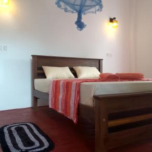 Una cama o camas en una habitación de Margosa Guesthouse