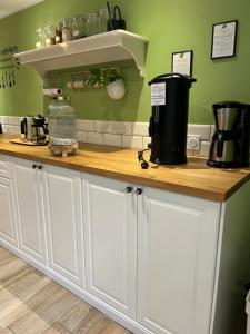 a kitchen with white cabinets and a counter top at Clos du Régrillon in Pélussin