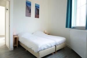 a small bedroom with a bed and a window at Watertoren Vlissingen in Vlissingen +64 photos