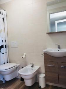 a bathroom with a sink and a toilet and a mirror at B&B I Falchi Pellegrini in Monzuno