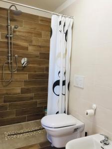 a bathroom with a toilet and a shower at B&B I Falchi Pellegrini in Monzuno