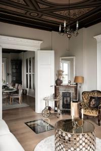 a living room with a couch and a fireplace at Room in exclusive villa in sentral Oslo in Oslo