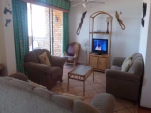 a living room with a couch and a tv at Villa Siesta Flat No 5 in Margate