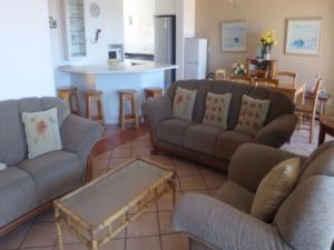 a living room with two couches and a kitchen at Villa Siesta Flat No 5 in Margate