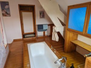 a bathroom with a white tub and a sink at Chambre 3, Le clos du Ru in Presnoy +34 photos