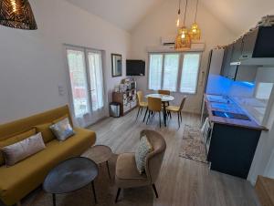 a living room with a couch and a table at Chambre Une Rive au Loing in Montargis