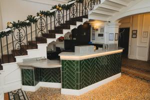 a lobby with a stairway with a counter at Aston Hall Hotel, BW Signature Collection in Sheffield