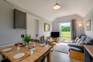 The Bolthole and Warren في Biddenden: غرفة معيشة بها طاولة وأريكة