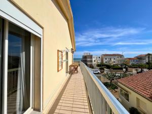 Un balcón de una casa con vista al mar. en Brise Marine - Appartement 2 chambres avec balcon, vue mer & parking privé à 30 m de la plage, en Palavas-les-Flots