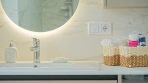 a bathroom counter with a sink and a mirror at Le Luna Apart in Braşov +24 photos