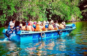 a group of people in a blue boat on a river at Harshi Guest House in Matara