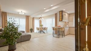 a living room and kitchen with a couch and a table at Le Luna Apart in Braşov