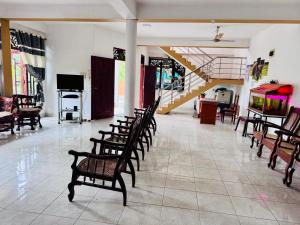 a room with a bunch of chairs and a staircase at Harshi Guest House in Matara