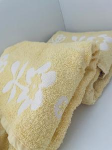 a towel with a white flower pattern on it at Lofts Inverno Centro Histórico in Paraty +110 photos