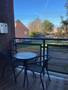 a table and two chairs on a balcony at Bowery Apartment - 2 Bedrooms 1st floor in Dagenham
