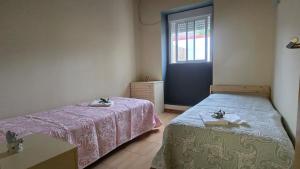 Postel nebo postele na pokoji v ubytování DomusCavadas