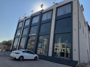 a white car parked in front of a building at Hotel The Luxury Inn in Nāgaur