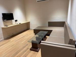 an empty room with a bench and a tv at Hotel The Luxury Inn in Nāgaur