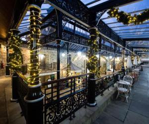 a patio with christmas lights and tables and chairs at Victoria Boutique Apartment in Skipton