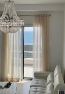 un soggiorno con un divano e un lampadario di Villa Morion a Donji Morinj