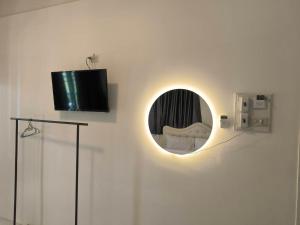 a room with a mirror and a tv on a wall at SB Betong GUESTHOUSE in Betong