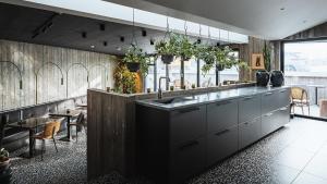 a kitchen with a counter with a sink and a table at Hotel Leifur Eiriksson in Reykjavík