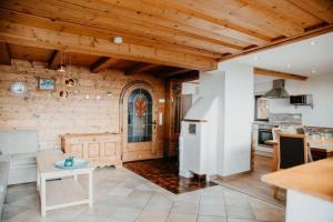 een keuken en een woonkamer met houten plafonds bij Berghütte Inntalblick in Erlerberg
