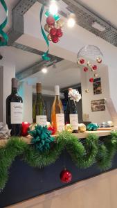 a counter with bottles of wine and christmas decorations at HOTEL JUAN B JUSTO GARDEN Pet friendly in Mendoza