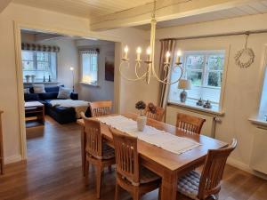 a dining room and living room with a table and chairs at Haus Oevenum in Oevenum +21 photos