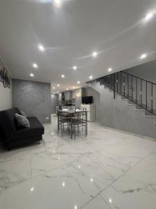 a living room with a black couch and a table at La 75 Stella Home Catania in Catania